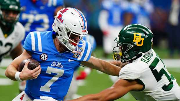 Jan 1, 2022; New Orleans, LA, USA; Mississippi Rebels quarterback Luke Altmyer (7) runs with the ball against Baylor Bears linebacker Garmon Randolph (55) during the first half in the 2022 Sugar Bowl at Caesars Superdome. Mandatory Credit: John David Mercer-USA TODAY Sports